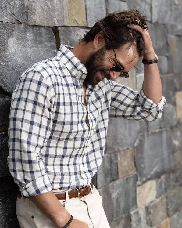 Man wearing a cream and navy lightweight plaid shirt