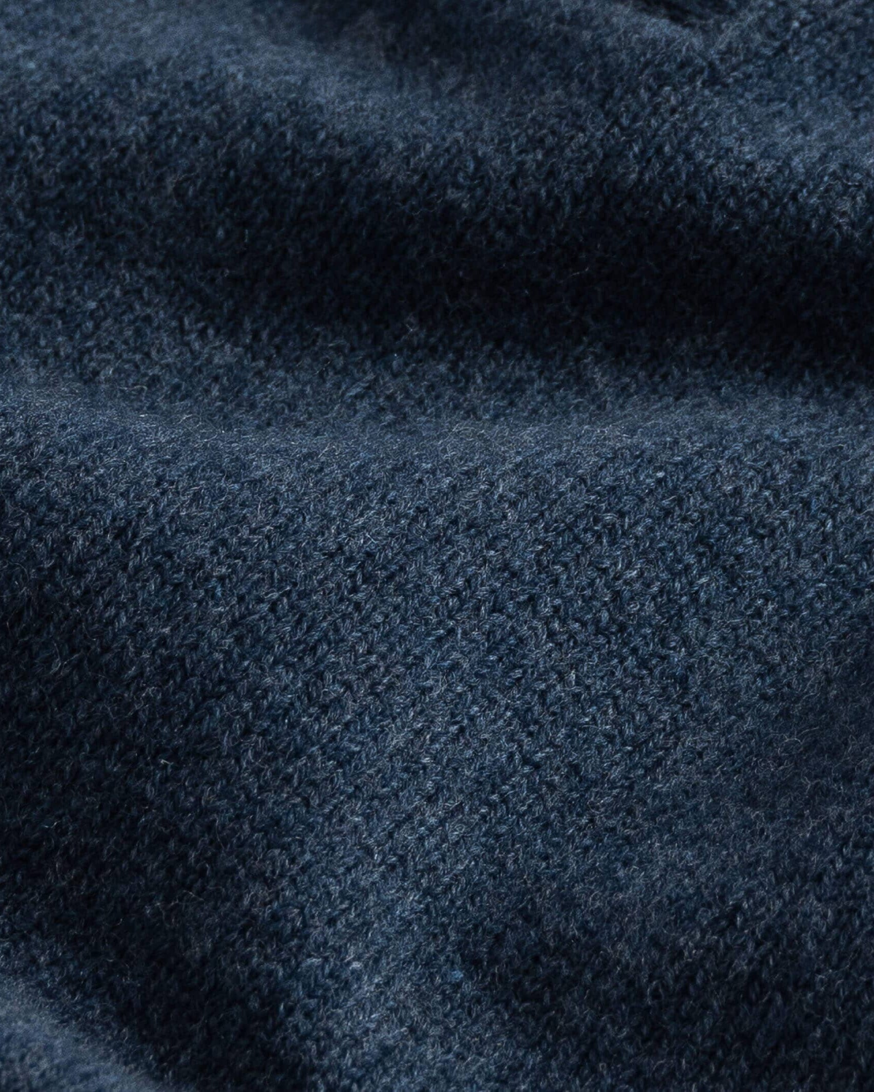 Close-up of blue heather superfine merino wool knit texture on the Brewer Mock Neck Sweater
