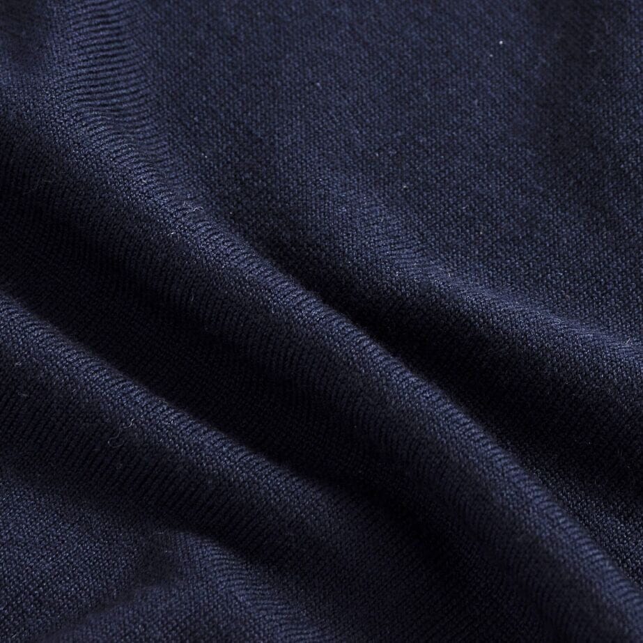 Close-up of 100% extrafine wool fabric on the Navy Emmons V-neck sweater