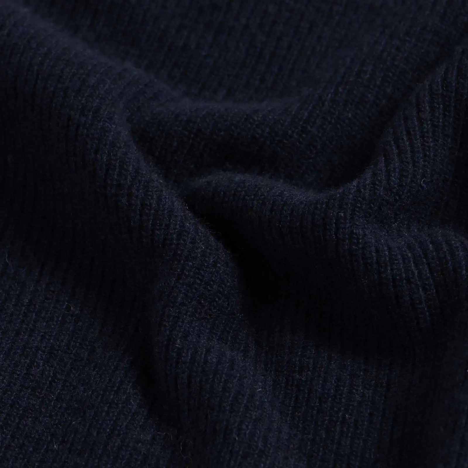 Close-up of 12gg rib wool blend fabric on the Navy Atwood knit collar sweater