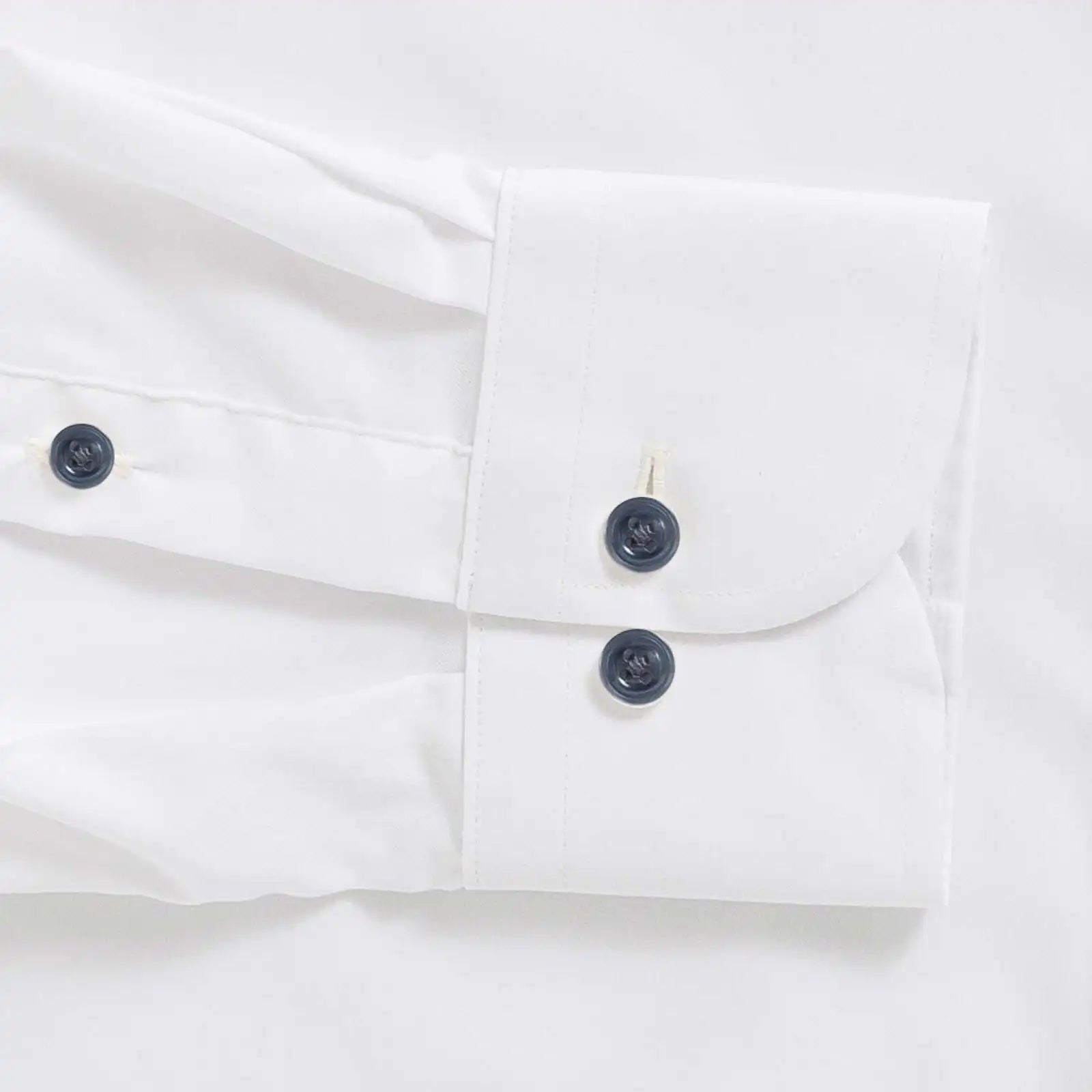 White performance dress shirt cuff with navy buttons - Journey Flex stretch fabric tailoring
