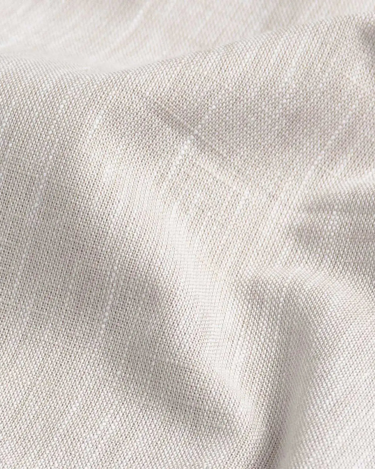 Ecru slub cotton oxford chambray fabric close-up - textured heathered weave