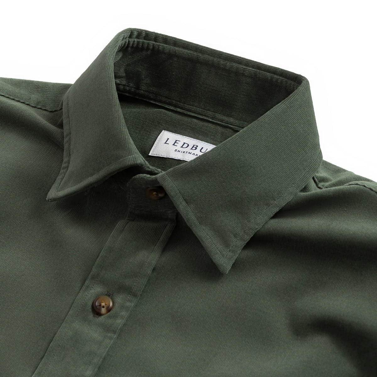 Close-up of a dark olive green button-down shirt collar with a visible Ledbury label, set against a plain white background.