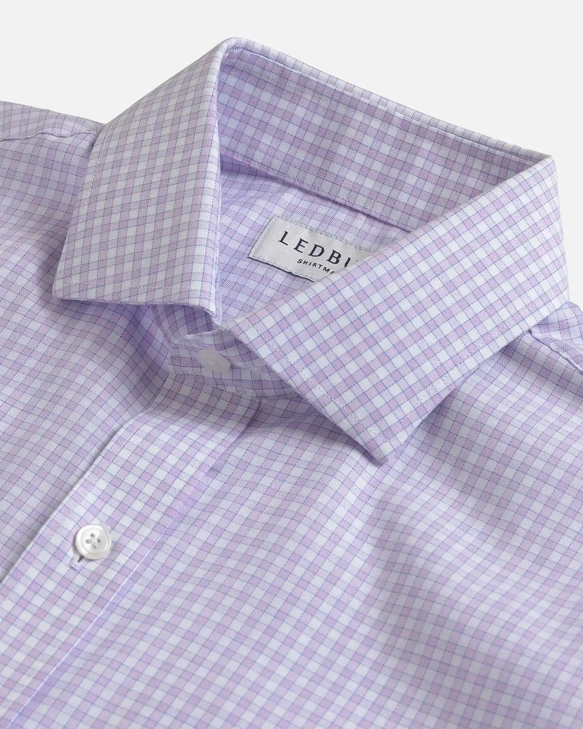 Close-up of a Ledbury men's dress shirt in a light purple and white gingham check pattern, showing the collar and button placket.