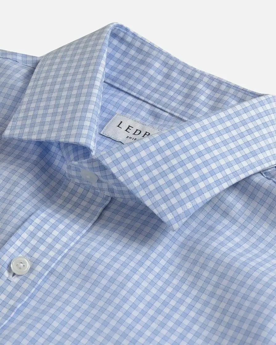 Close-up of a light blue and white gingham dress shirt collar with a visible Ledbury neck label.