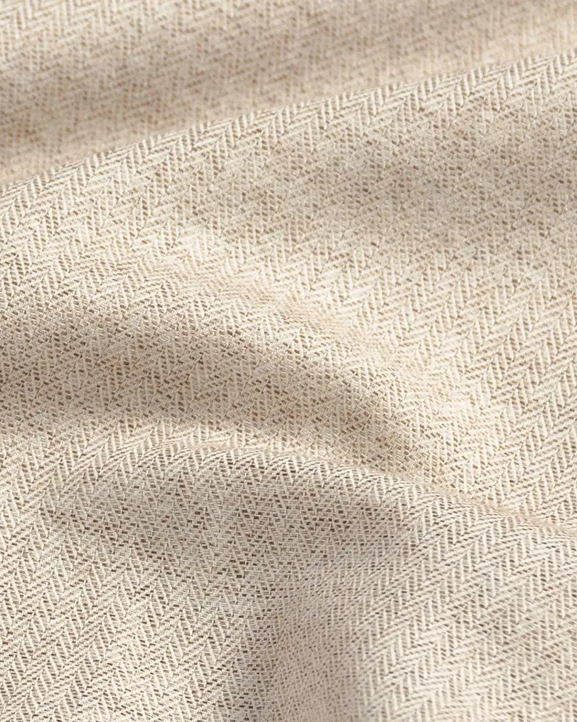 Close-up of an oatmeal fabric with a subtle herringbone pattern
