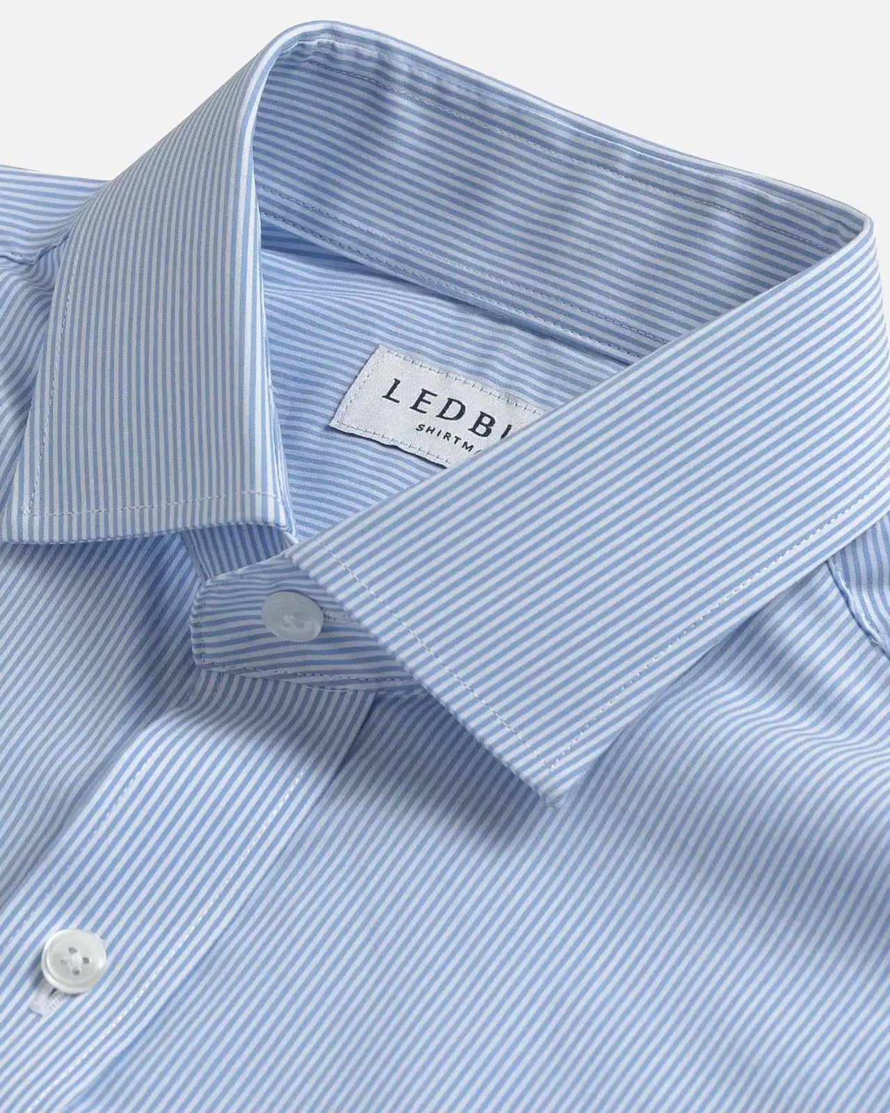Close-up of a light blue and white striped dress shirt collar by Ledbury