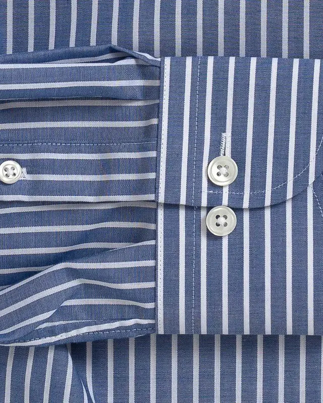 Close-up of a blue and white striped dress shirt showing the buttoned cuff and front placket fabric.