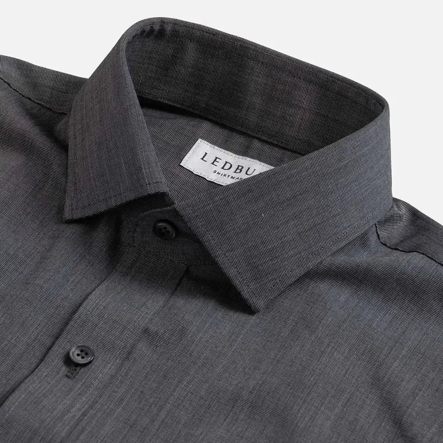 Close-up of a dark gray textured dress shirt collar with a visible LEDBURY brand label on a light gray background.
