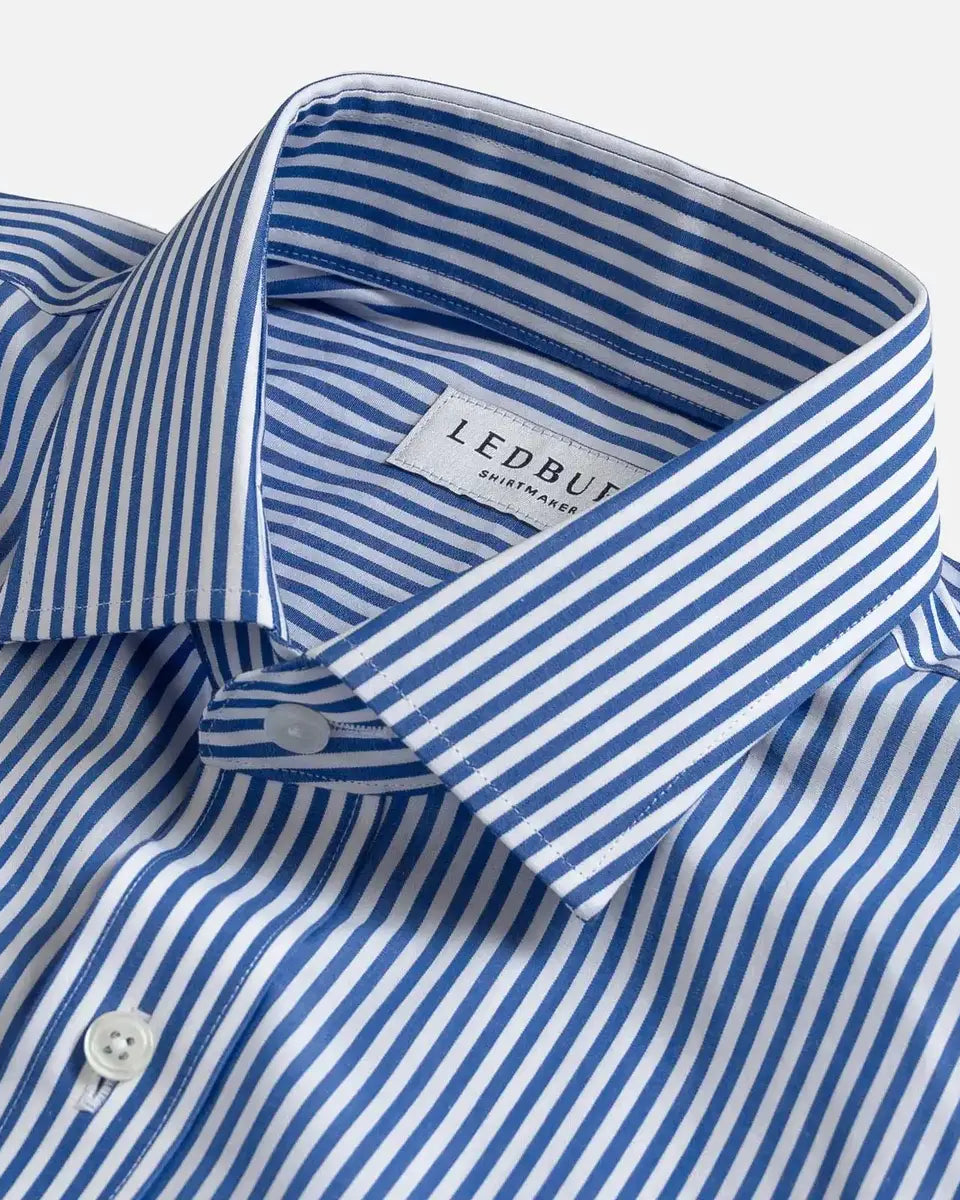 Close-up of a blue and white striped dress shirt collar with a visible LEDBURY label, shown on a light gray background.