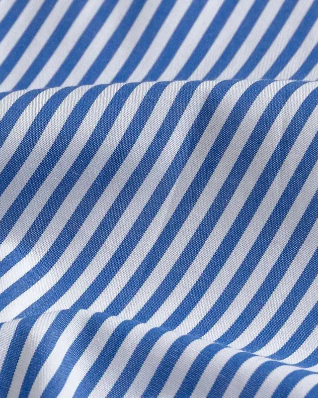 Blue and white striped fabric with a diagonal stripe pattern, shown with soft folds and texture.