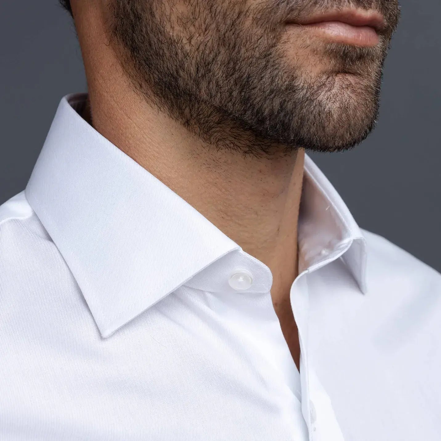 Non-iron white dress shirt close-up - wrinkle-resistant fine twill fabric detail"