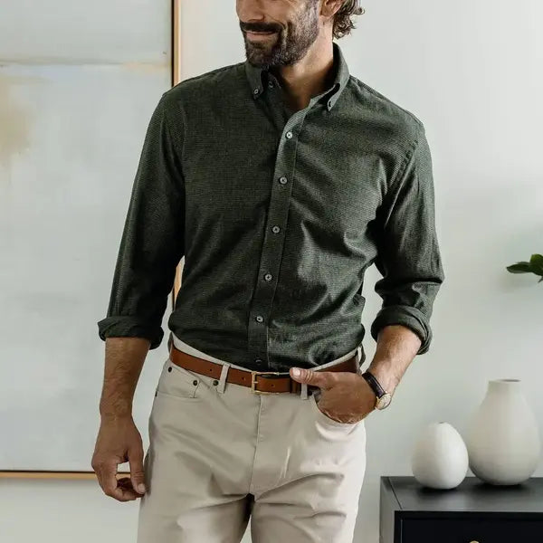 Man wearing a dark green houndstooth button down casual shirt 