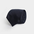 Navy Basso 100% silk jacquard tie with small-scale white dots — made in Italy by Ledbury