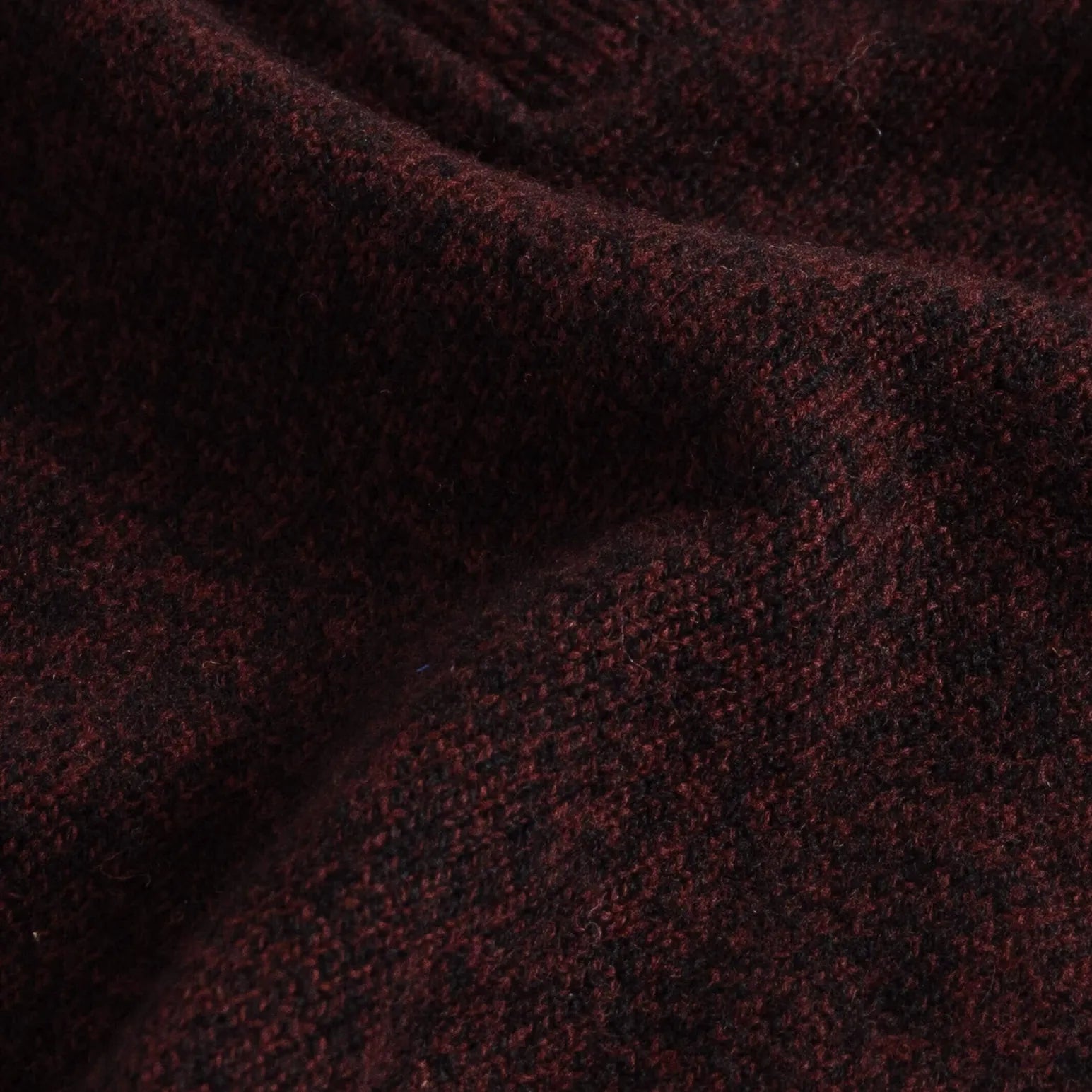 Close-up of dark burgundy superfine merino wool knit texture on the Brewer Mock Neck Sweater