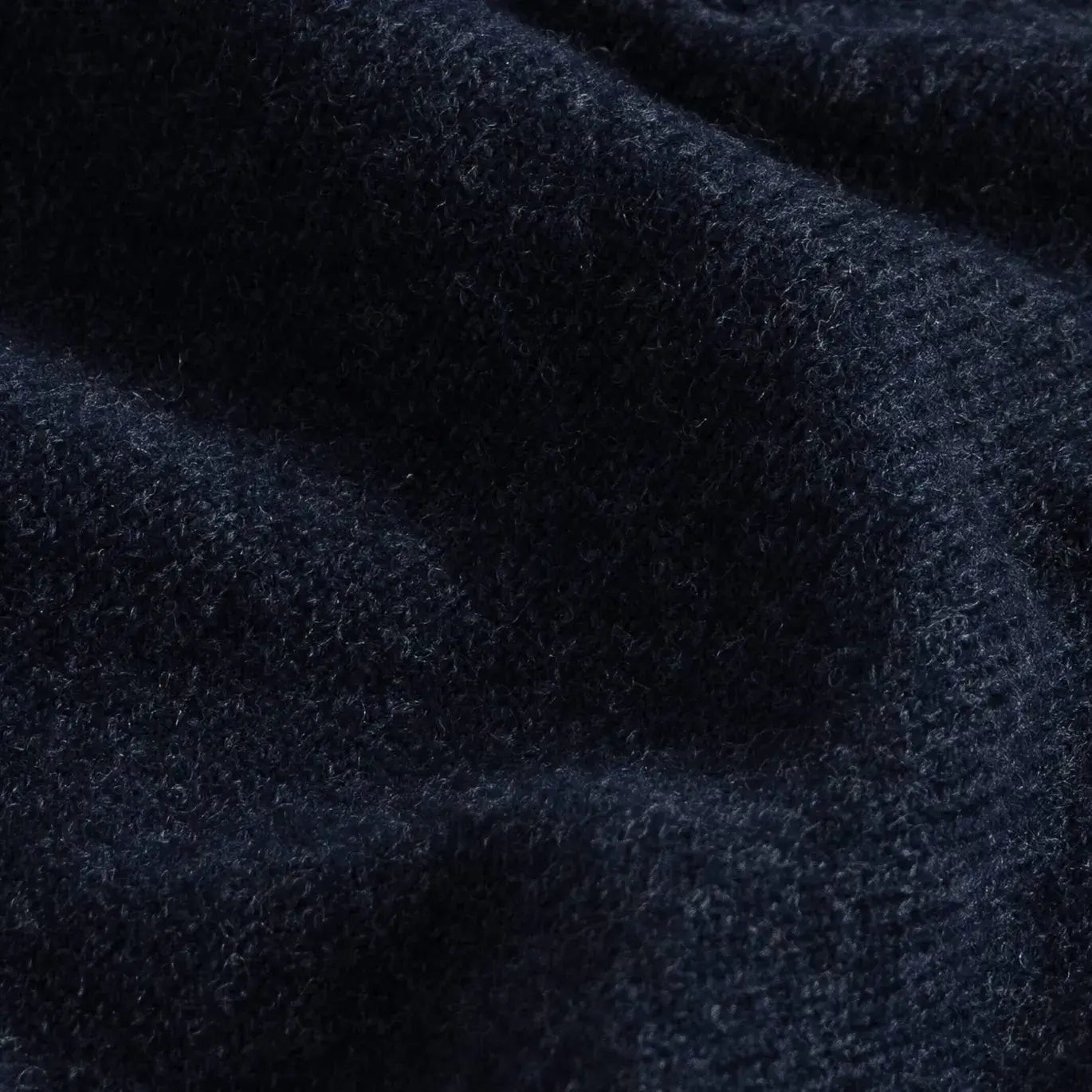 Close-up of navy heather superfine merino wool knit texture on the Brewer Mock Neck Sweater