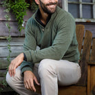 Sage Brewer Mock Neck Sweater styled outdoors, three-button mock collar detail visible