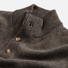 Closeup of the collar of a light brown mock neck Italian merino sweater. 