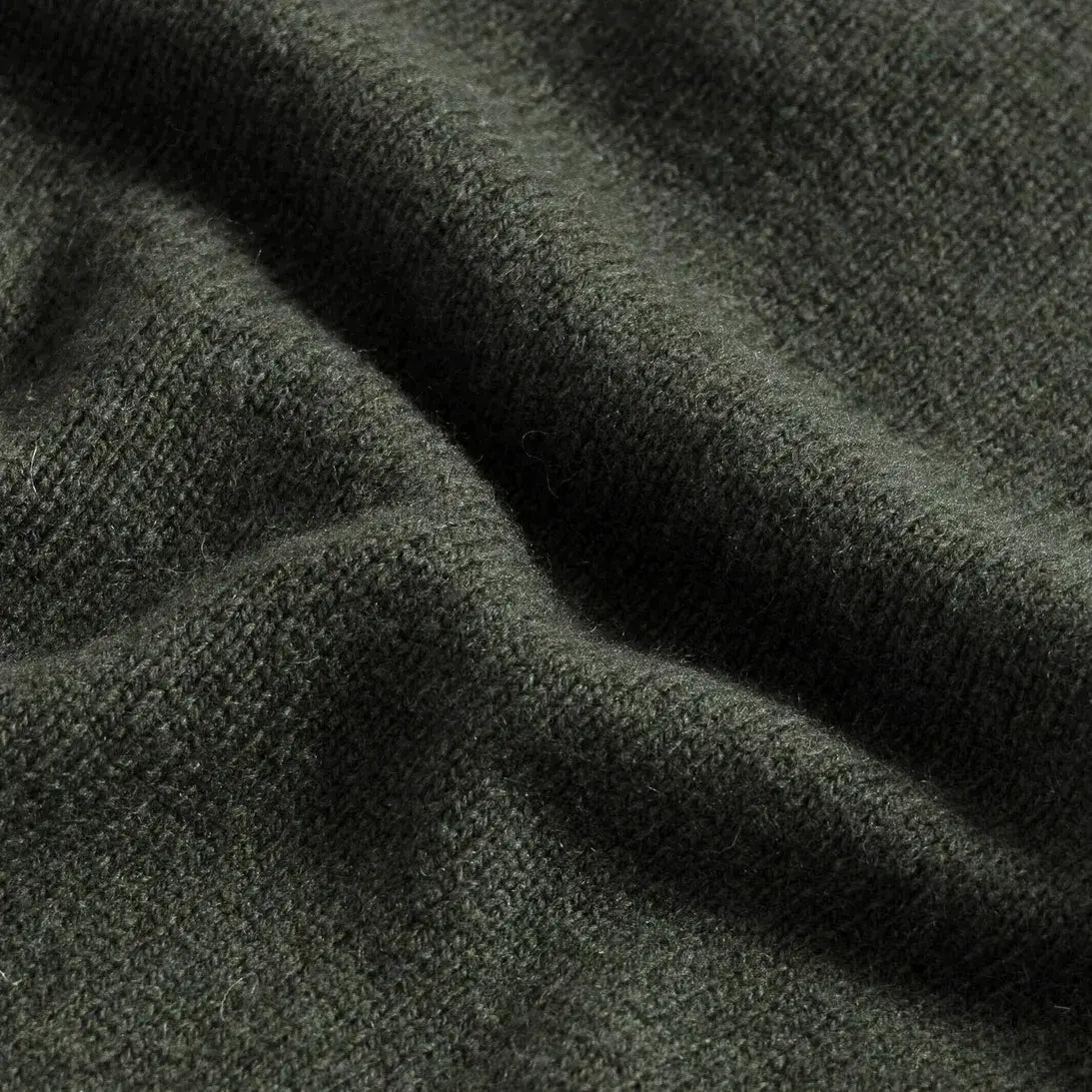Close-up of 90% merino wool 10% cashmere fabric on the Forest Ashton quarter-zip sweater