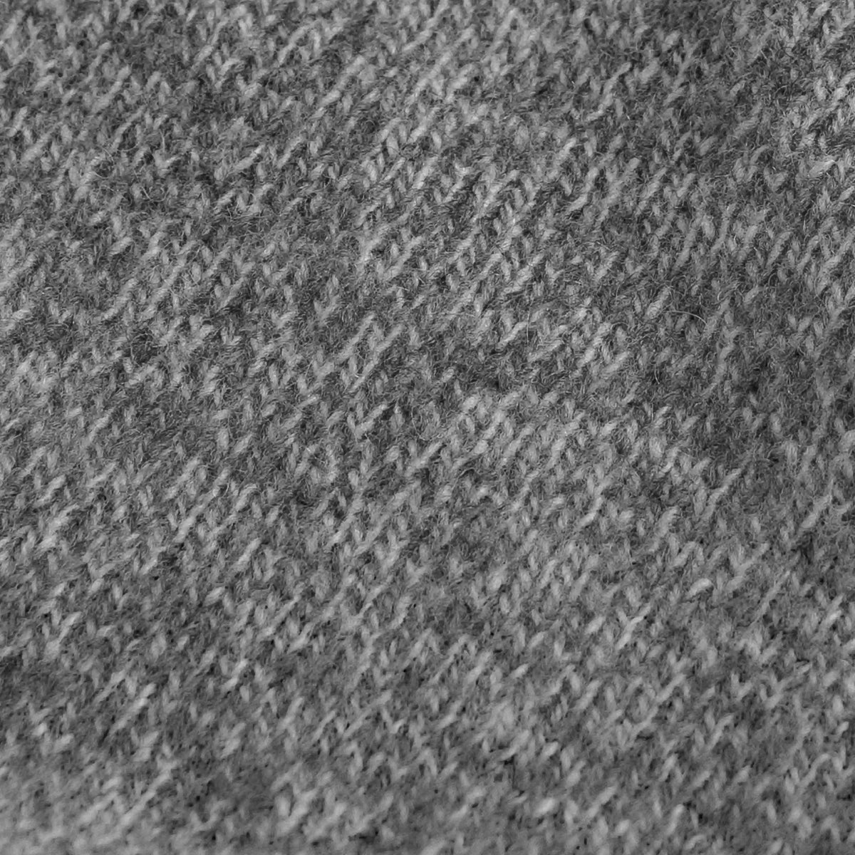 A close-up texture shot of a gray and white heathered knit fabric, showing a detailed woven pattern.