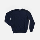 A dark navy blue crewneck sweater laid flat against a light gray background.