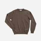 A brown crewneck knit sweater with long sleeves, laid flat against a light gray background.