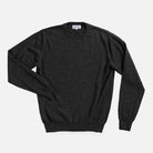A dark charcoal gray long-sleeve crewneck sweater laid flat against a light gray background.