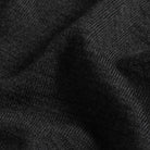 Close-up of a dark charcoal gray ribbed knit fabric texture with soft folds.