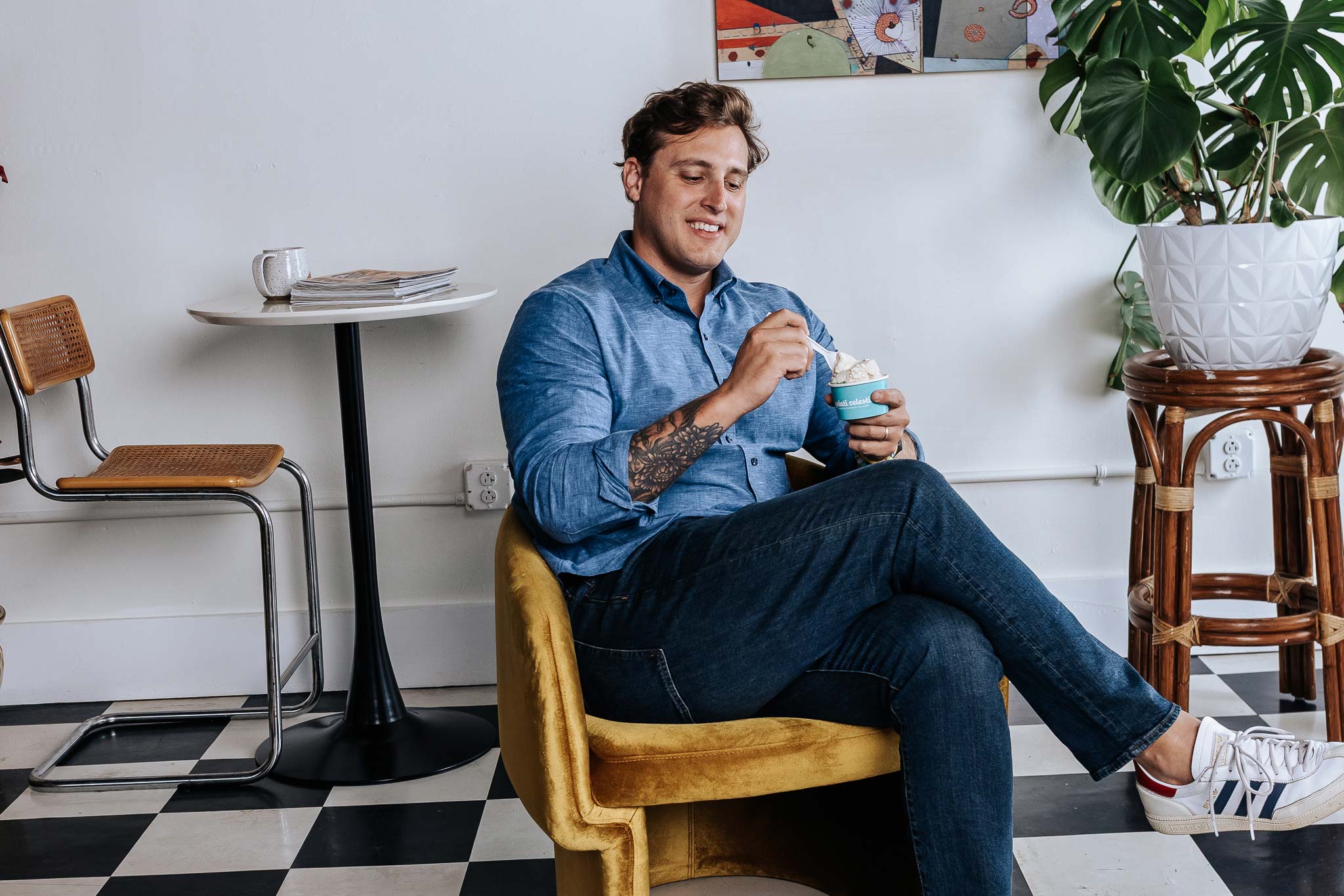 Man sitting in a chair eating ice cream in a casual setting