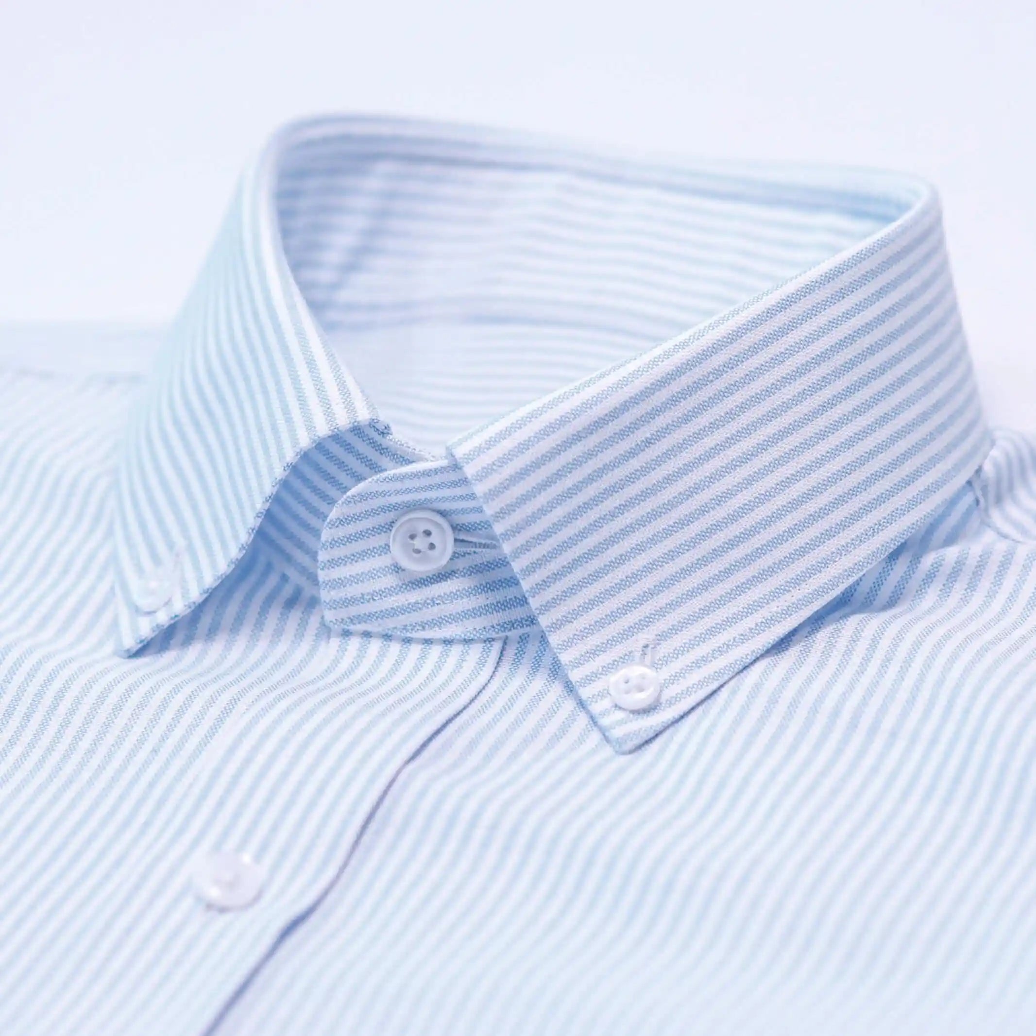 Light blue oxford stripe dress shirt collar detail and button placket
