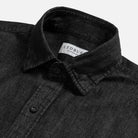 Washed black denim utility shirt collar detail - broken-in cotton construction