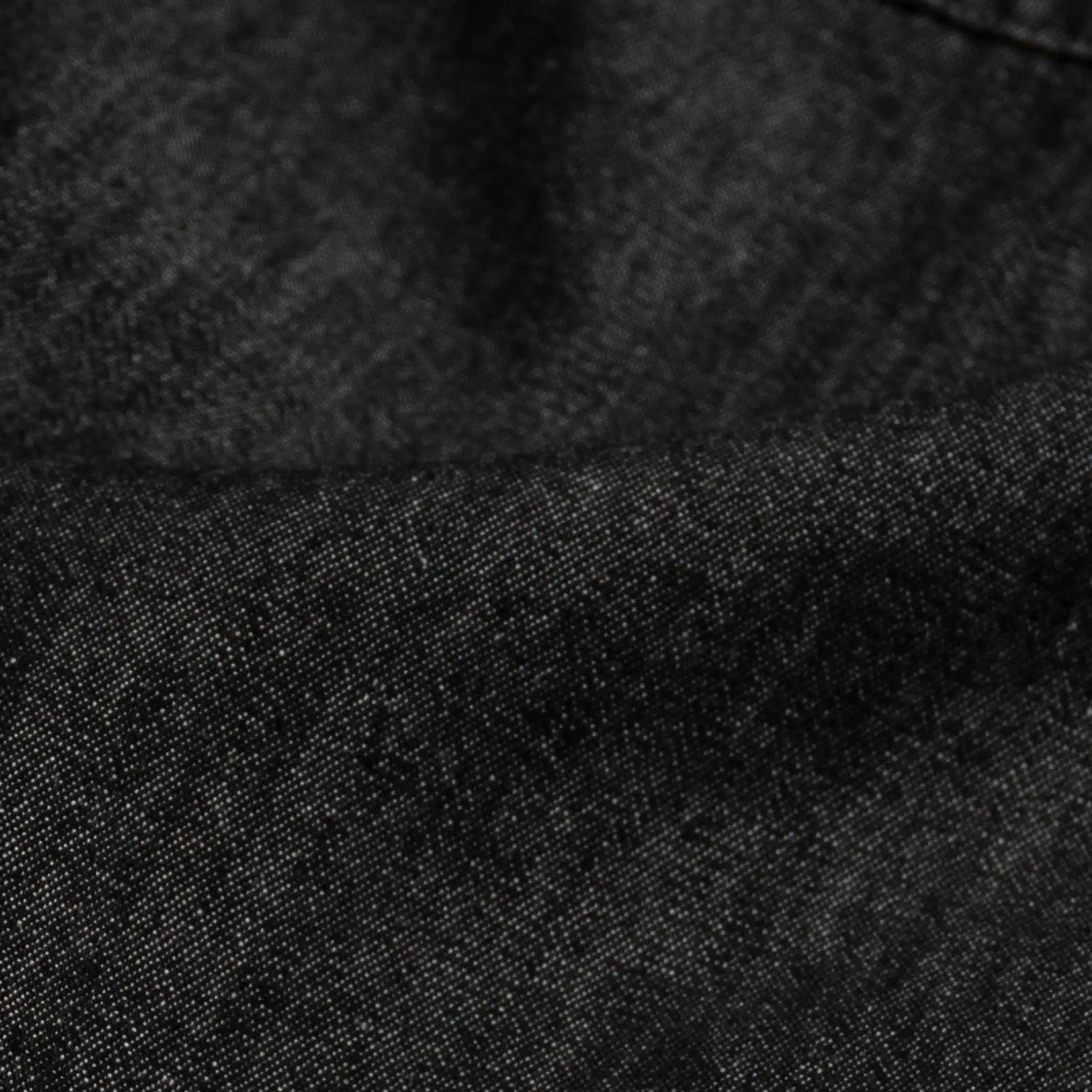 Washed black Slater denim fabric close-up - 100% cotton texture