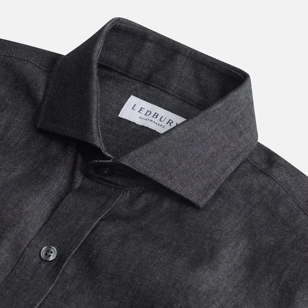 Washed black denim shirt collar detail - broken-in cotton construction