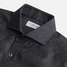 Washed black denim shirt collar detail - broken-in cotton construction