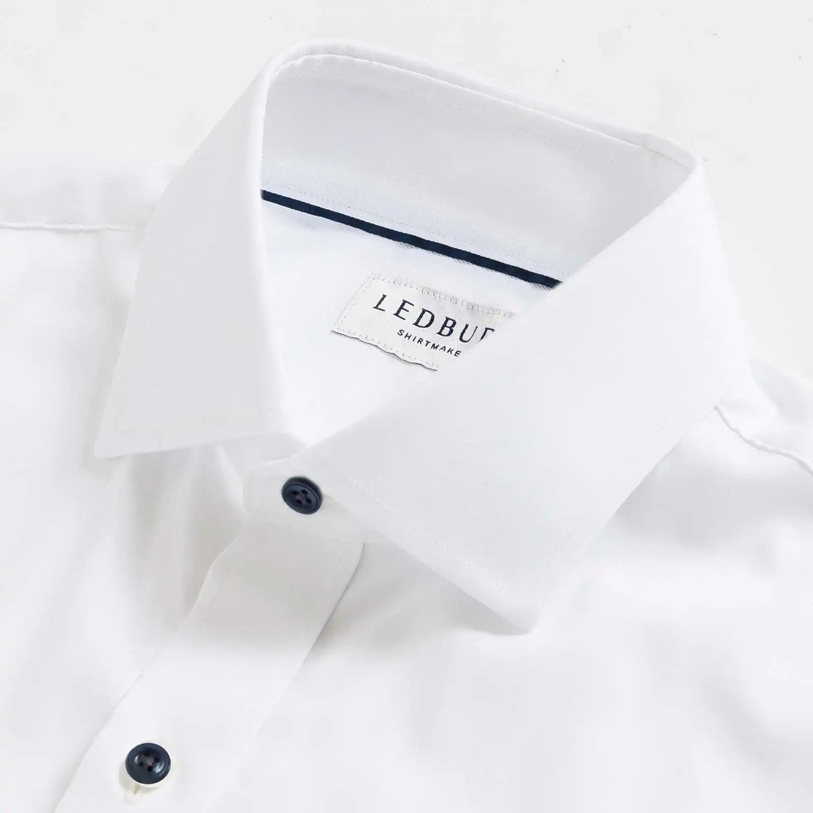 Custom dress shirt collar detail with navy buttons - Journey Flex white performance fabric construction