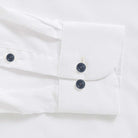 White performance dress shirt cuff with navy buttons - Journey Flex stretch fabric tailoring