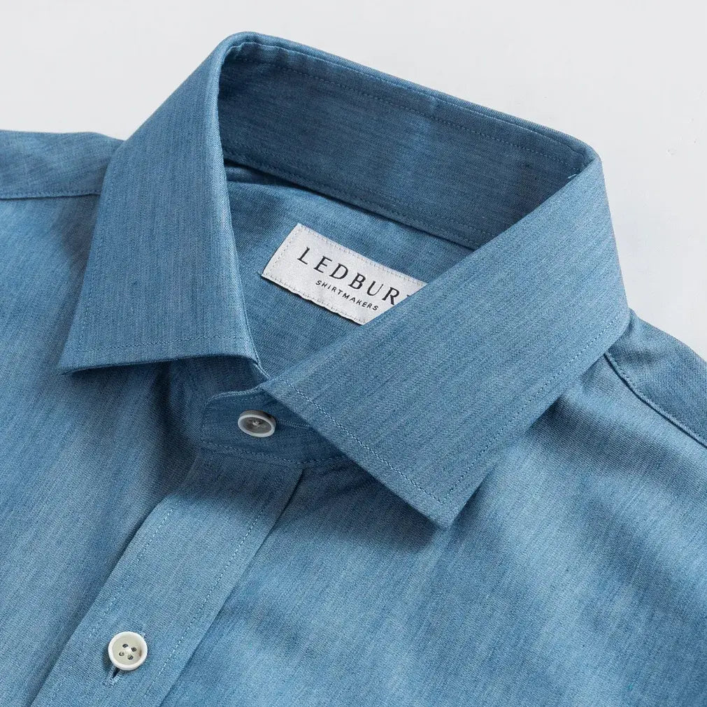Blue chambray dress shirt collar detail - 100% cotton construction
