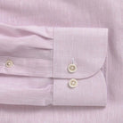 Close-up of a light pink heathered cotton shirt with button details