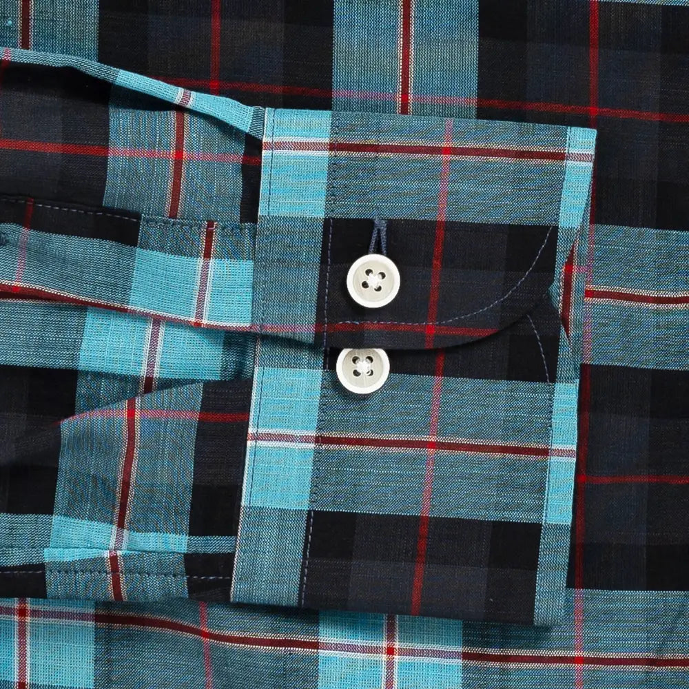 Close-up of Ledbury Olson Plaid double button barrel cuff in teal and navy plaid cotton chambray