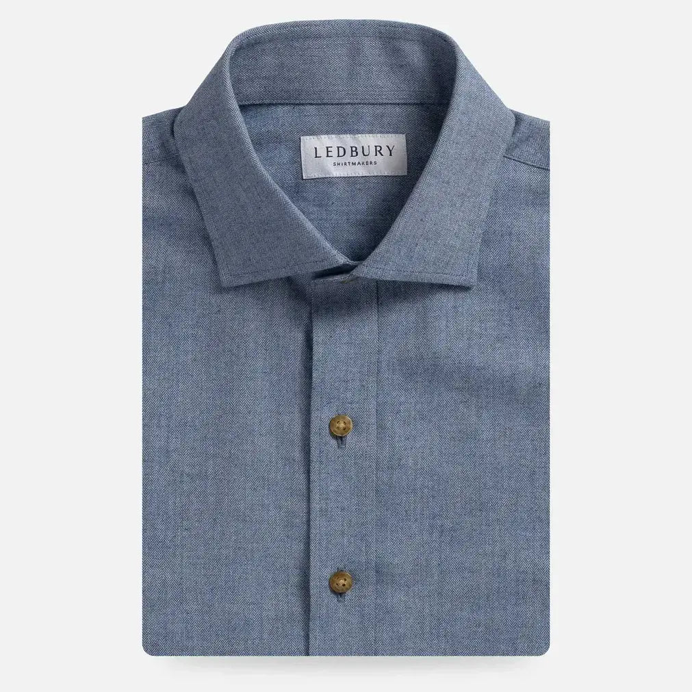 Blue button down dress shirt with herringbone texture. It has a 'Ledbury' label on a white background.