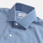 A close-up of a light blue dress shirt collar with a visible LEDBURY brand label, showing the collar point, buttons, and fabric texture against a clean light background.