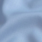 Light blue Merino wool fabric close-up - Ledbury Reda stretch with matte horn buttons
