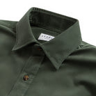 Close-up of a dark olive green button-down shirt collar with a visible Ledbury label, set against a plain white background.