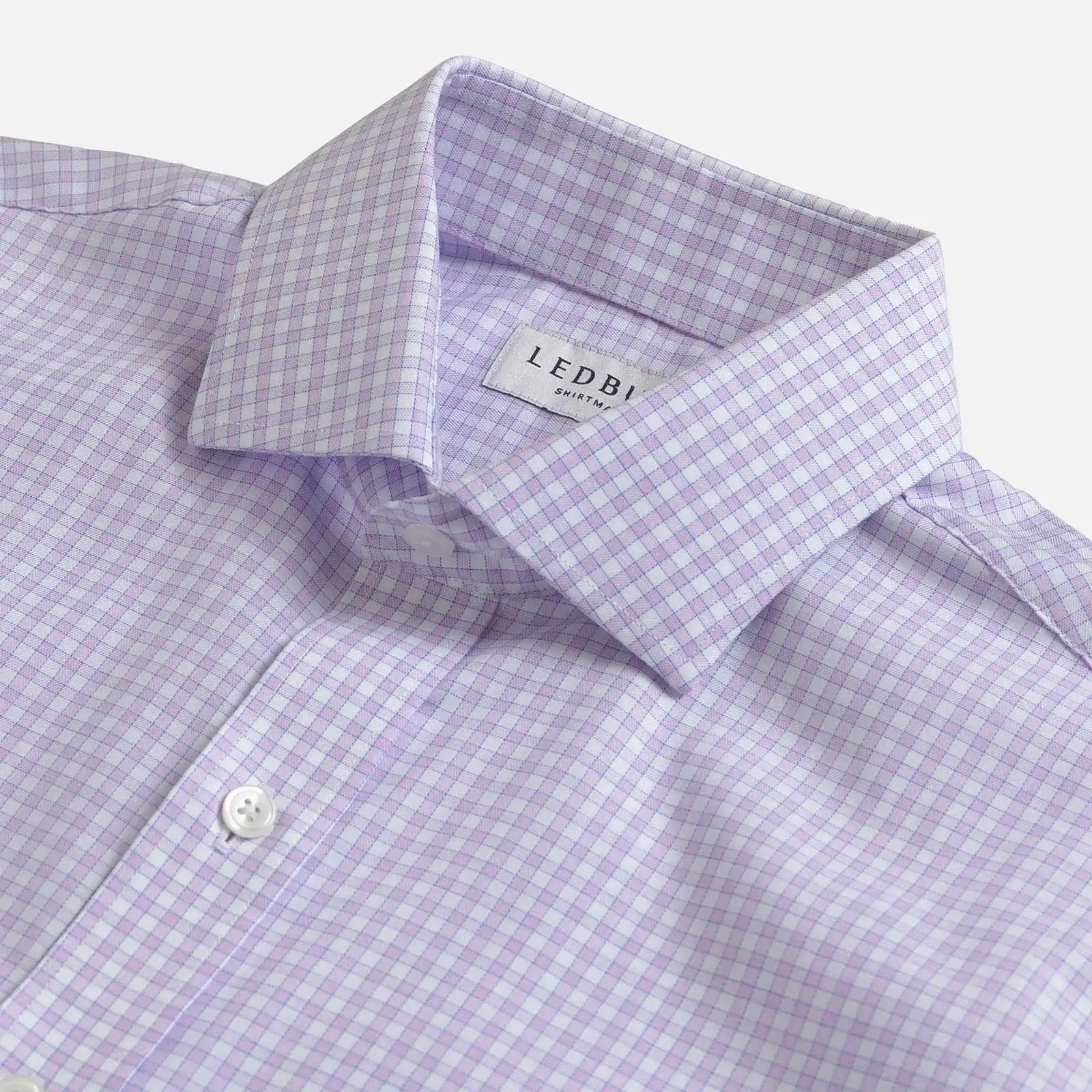 Close-up of a Ledbury men's dress shirt in a light purple and white gingham check pattern, showing the collar and button placket.