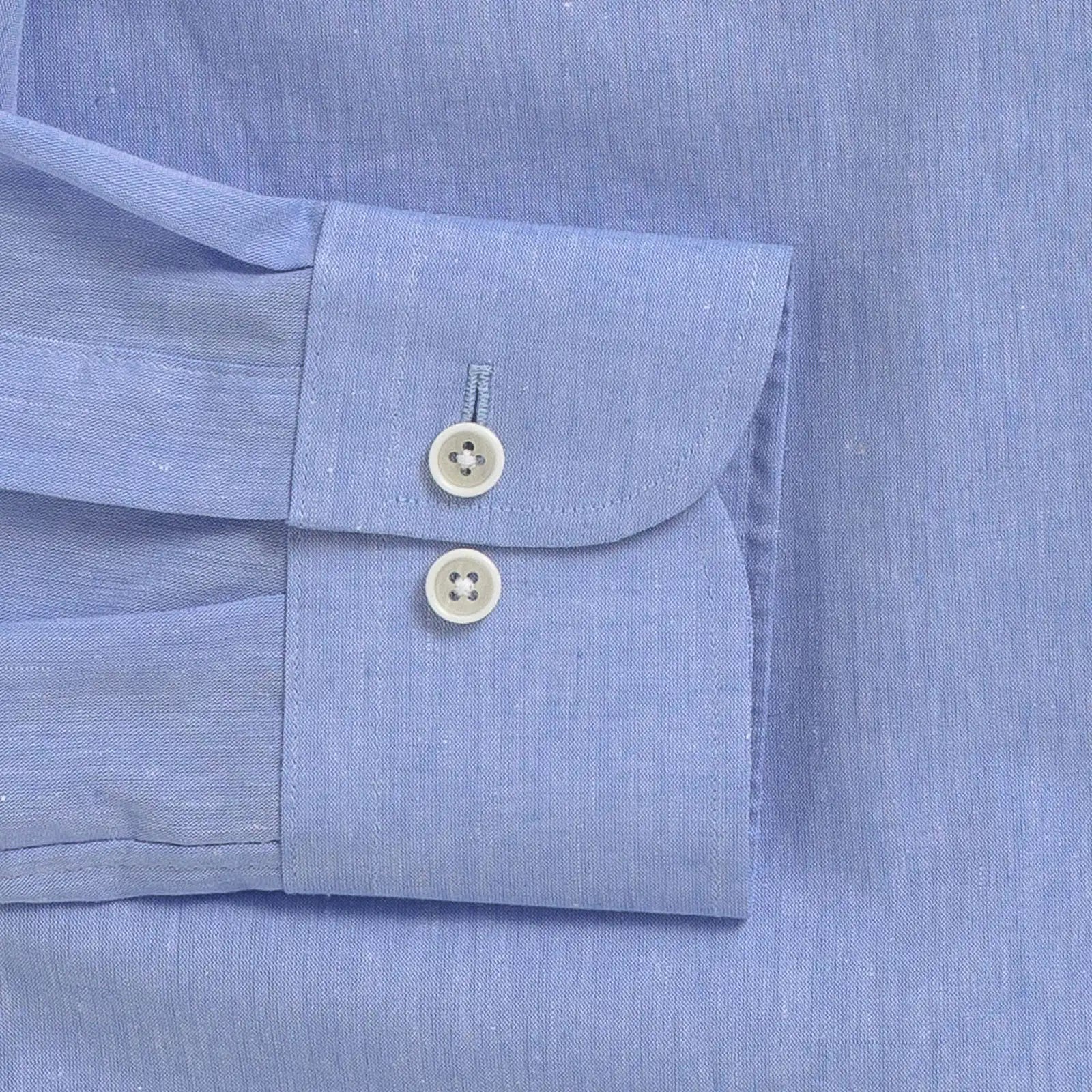 Close up of the sleeve on a men's cotton/linen light blue shirt by Ledbury