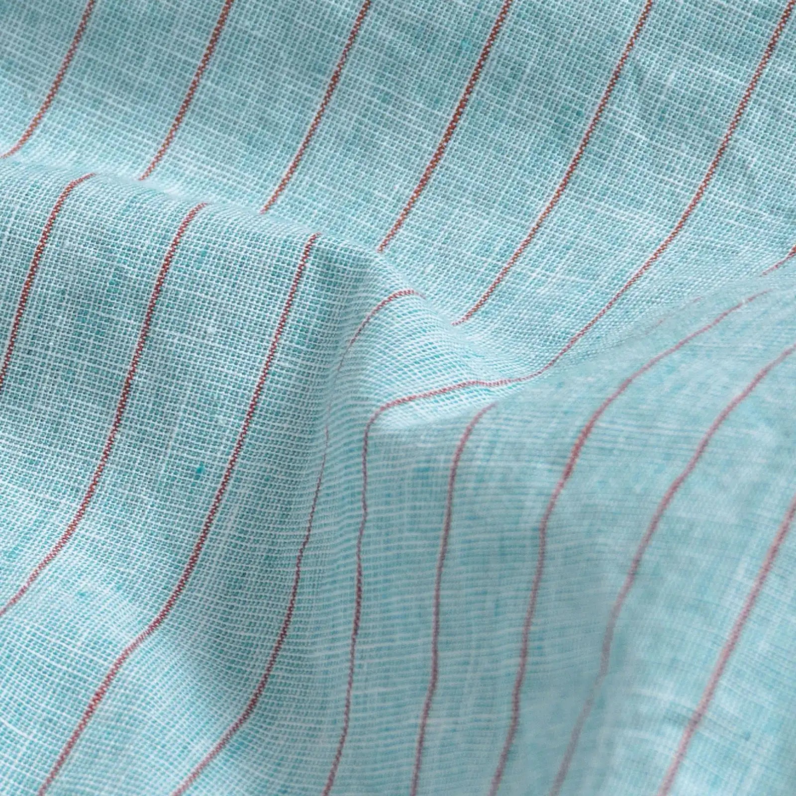 Close-up of sea green stripe fabric texture on the Barretto cotton-linen shirt