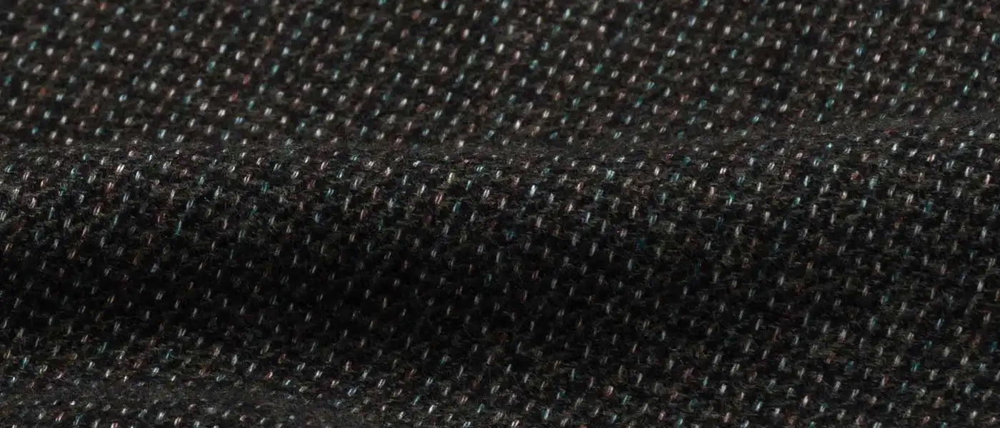 Close-up of very dark green textured fabric