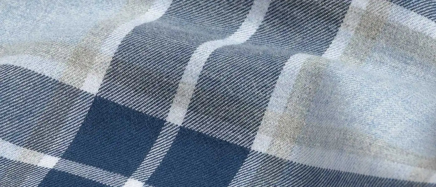 Close-up of a checkered fabric with blue grey and beige pattern