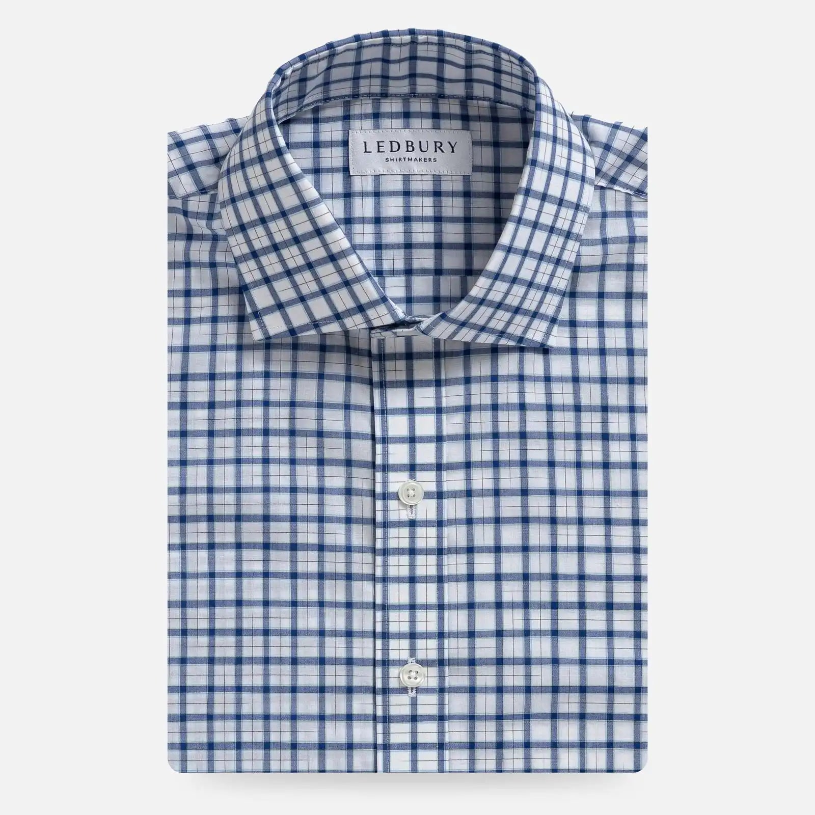 Ledbury Blue Guyer Check Custom Shirt folded flat, blue tattersall check on white cotton poplin with semi spread collar