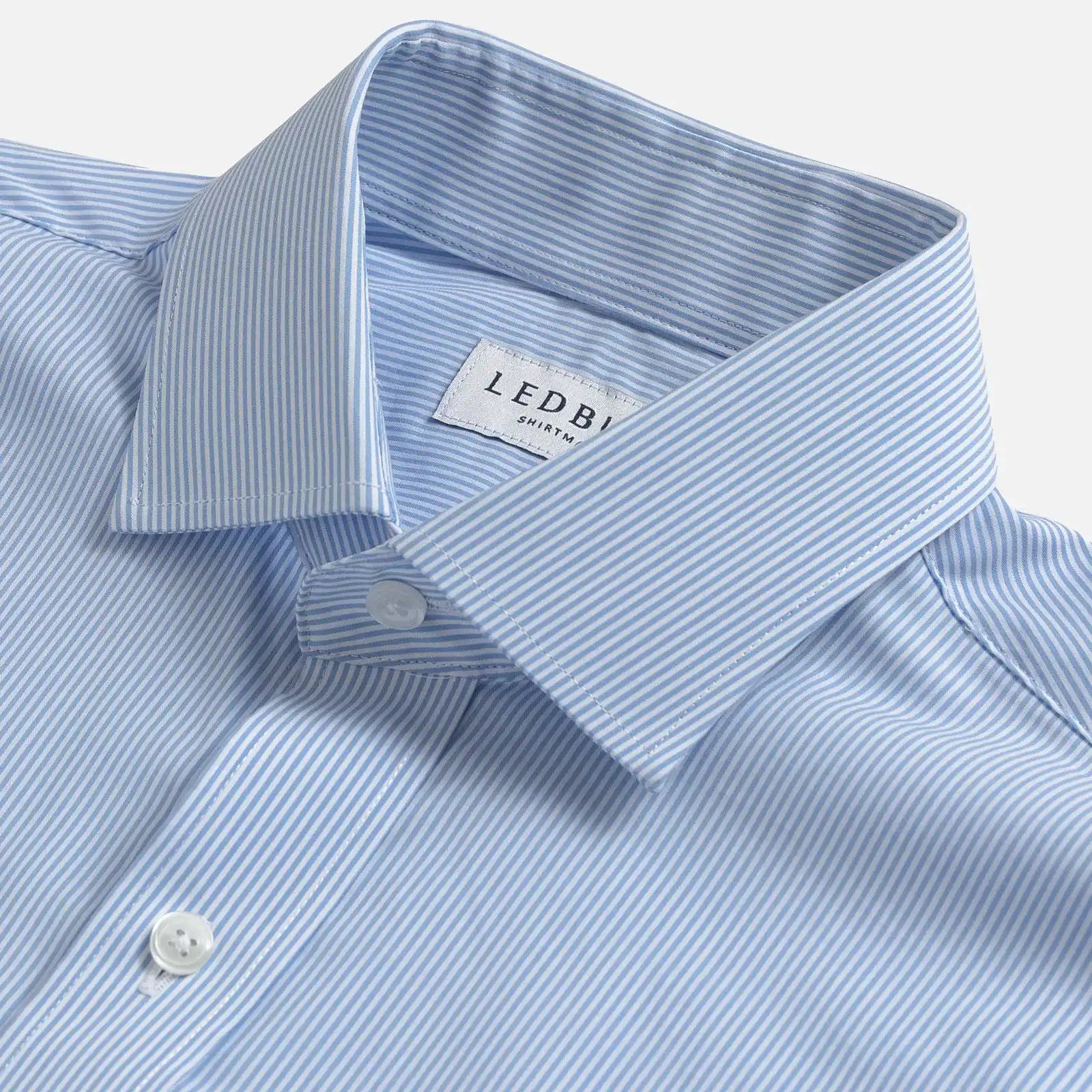Close-up of a light blue and white striped dress shirt collar by Ledbury